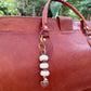 The Tenderness She Carries — Handmade Bag Jewelry