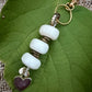 The Tenderness She Carries — Handmade Bag Jewelry